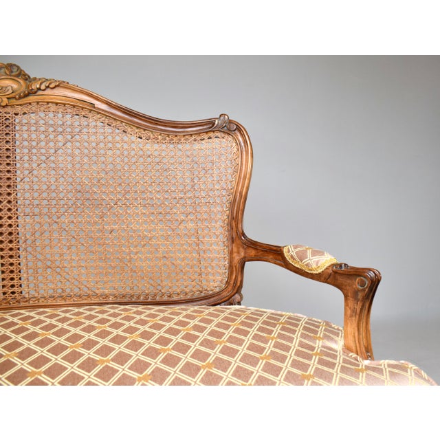 Exquisite Louis XV style hand carved French caned settee with loose notched cushion. Crafted in Italy c. 1980's, ready for...
