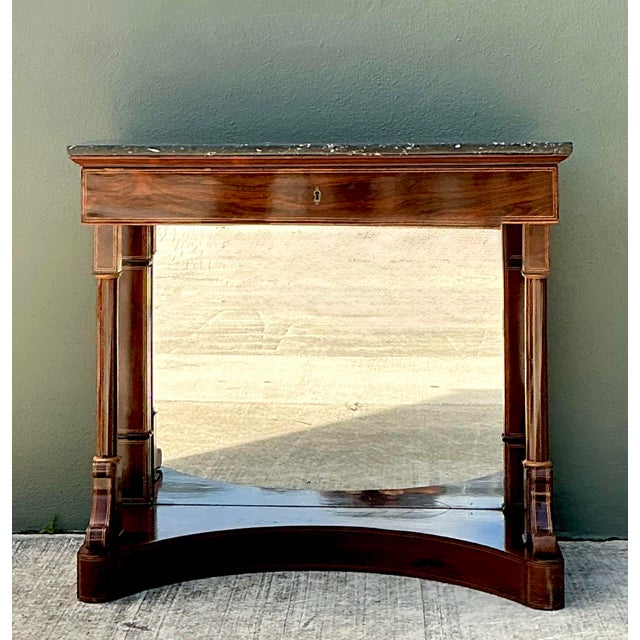 This magnificent Empire-style pier table is a masterwork of Neoclassical design, characterized by its architectural...