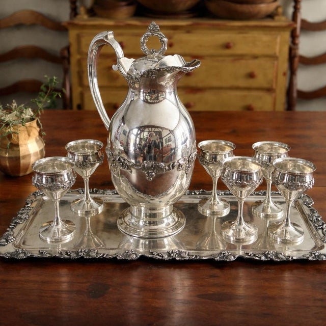 An elegant early 20th-century silverplate liqueur service by the respected American maker Homan Silver Company of...