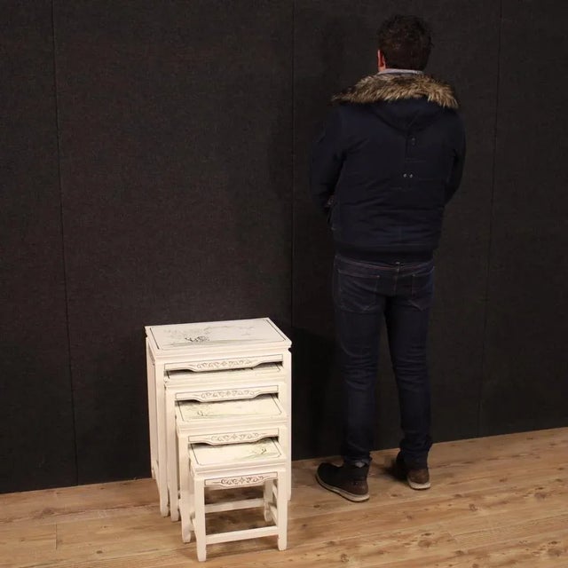 Four French interlocking coffee tables from the 60s / 70s. Furniture in lacquered and painted wood with very pleasant...