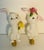 Whimsical glazed porcelain rabbit pair mounted on brass bases as lamp finials.