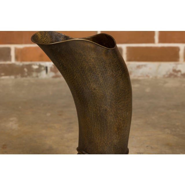 An English hand-hammered brass and copper musketeer boot umbrella stand from circa 1920 with front buckle. Step into a...