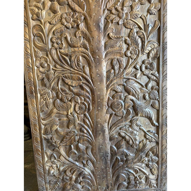 Celebrate timeless craftsmanship with this hand-carved solid wood wall panel featuring an intricate Floral Tree of Life...