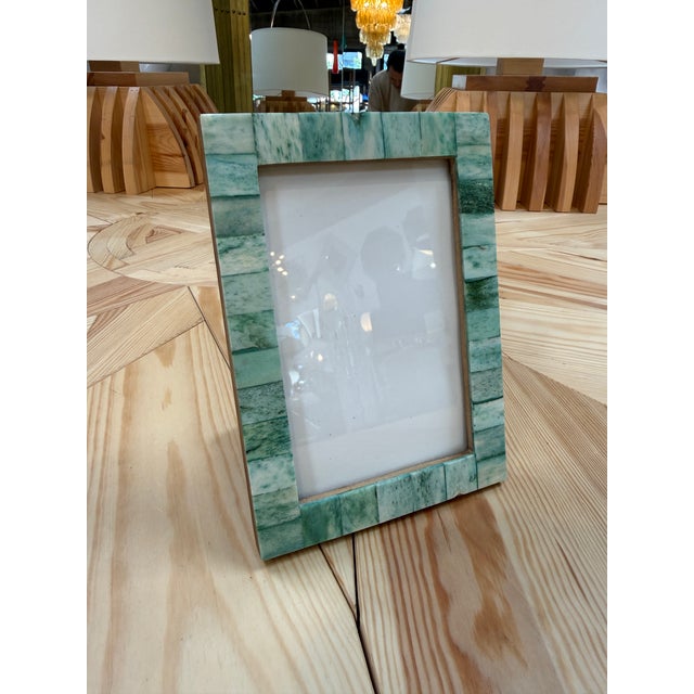 Elegant vintage picture frame featuring a mosaic-style border composed of rectangular green stone tiles. The natural...