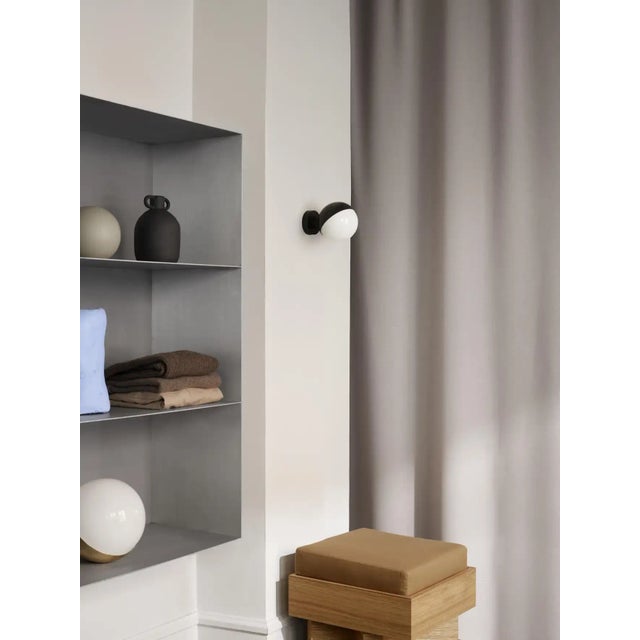 Vilhelm Lauritzen 'VL Studio' brass and glass wall lamp for Louis Poulsen. This innovative lamp is based on Lauritzen's...