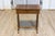 An Italian walnut side table from the 19th century with inlaid banding, single drawer, turned trestle base and cross...