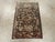 This early 20th-century Persian Malayer sampler rug presents a compact yet richly varied floral composition across a deep...
