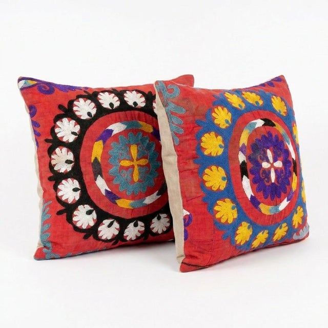 This beautiful 21'' x 22'' hand-embroidered Suzani pillow cover set was made from authentic Uzbek cotton fabric. The...