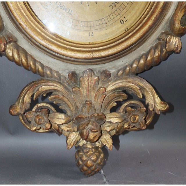 A finely carced and polychromed Italian Louis XVI style barometer. The colors are pale blue and white. This piece is from...