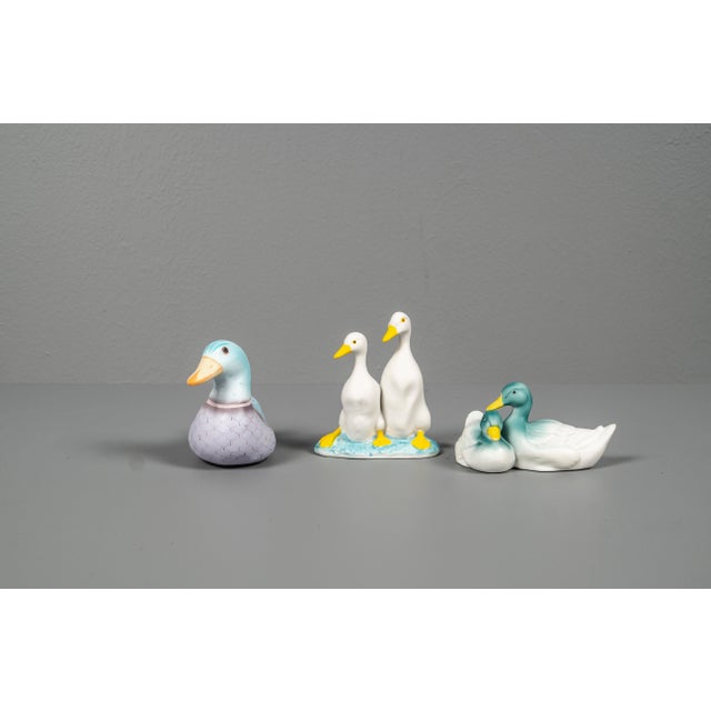 Decorative set of Porcelain ducks figures. The ducks feature warm green and lilac and yellow tones with finely hand-...