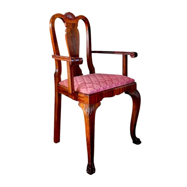 A stately set of 8 English George II dining chairs, circa 1740, consisting of 7 side chairs and one carver’s chair....