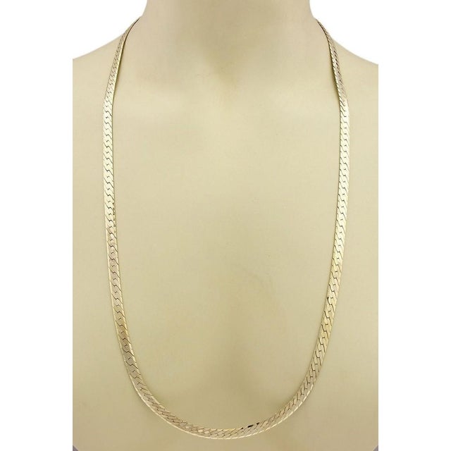The Herringbone 14k Yellow Gold Wide Necklace is a striking vintage piece that exudes sophistication and style. With its...