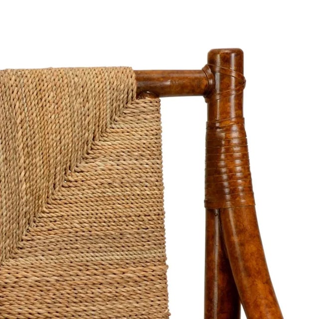 Mottled brown rattan chair with natural rush seat.