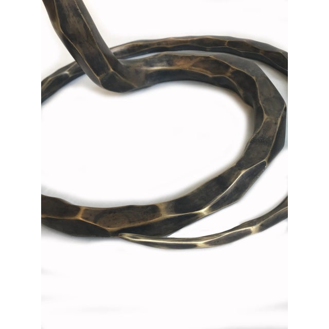 Functional sculpture that has a presence. Bronze, oil rubbed body, tiger eye and precious stone top