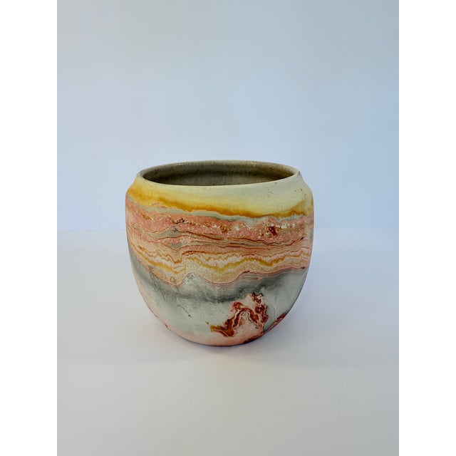 Small vintage Nemadji Bowl featuring a swirled red, orange and yellow design. Produced in Minnesota from clay on the banks...