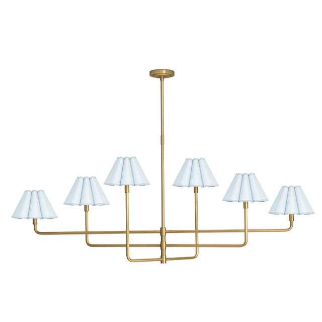 The Polly Chandelier embodies grace and versatility with its six shades, delicately crafted from mist blue linen and sewn...