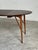 Newly refinished mid century modern walnut dining table, featuring tapered legs and a 19.75" removable leaf, allowing the...