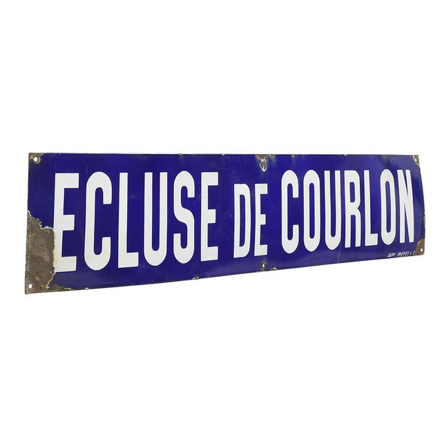 Large enamel sign indicating "Courlon lock". This piece is designed in the style of the selected designer and/or manufacturer