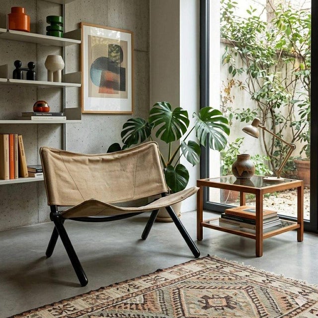 Folding armchair, it features an enamelled metal frame, fabric seat and backrest. Decent condition. This piece is...