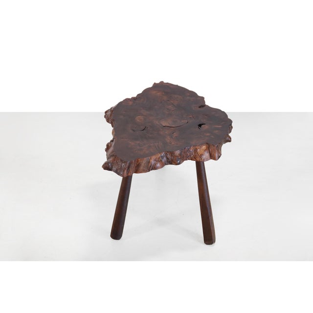 Unique coffee table from France. Made from a slice of burl wood on 3 wooden legs in the style of Carl Aubock. Burl is the...