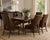A striking set of six authentic McGuire Furniture dining chairs blending organic texture with refined coastal...