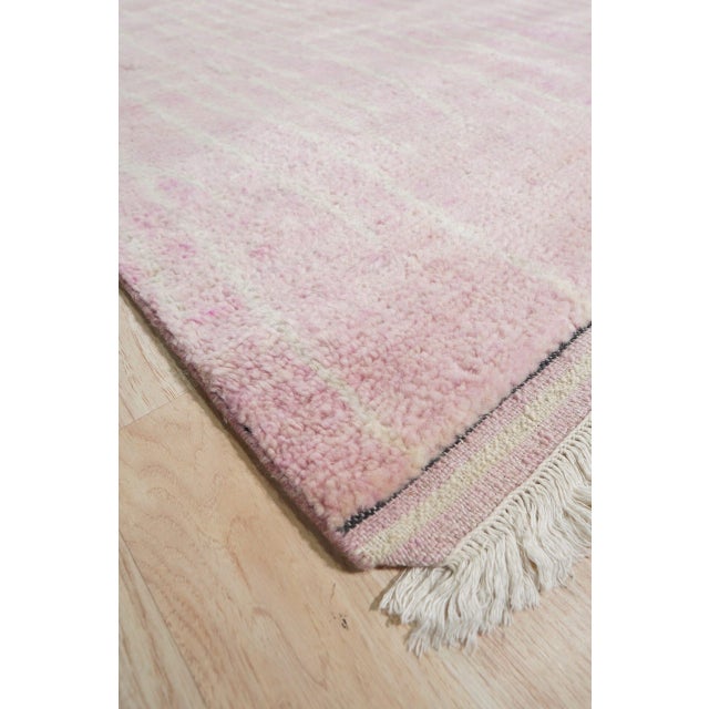 Rhea Moroccan Coral Hand Knotted Wool Rug, Country of Origin: India. This luxurious piece translates the iconic simplicity...