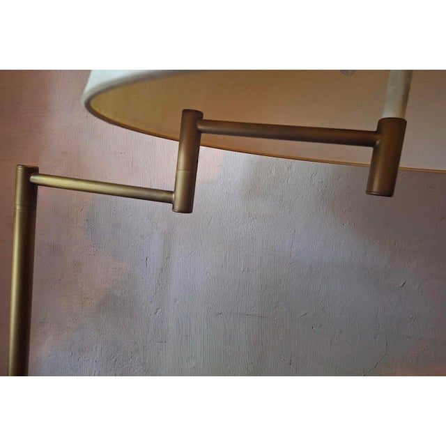 Walter von Nessen multi-adjustable swing-arm floor lamp in brass with an uplight, USA 1960s. I have official proof of...