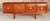 A midcentury teak sideboard by stonehill furniture, dating to the 1960s. The piece features a balanced layout split into...