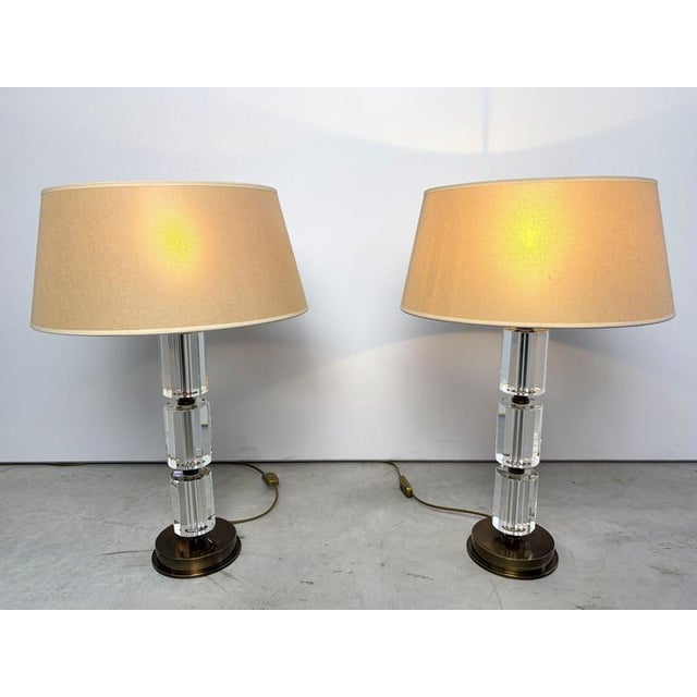 Pair of beautiful brass and acrylic table lamps. The lamps remain in a perfect condition and with their original lamps...