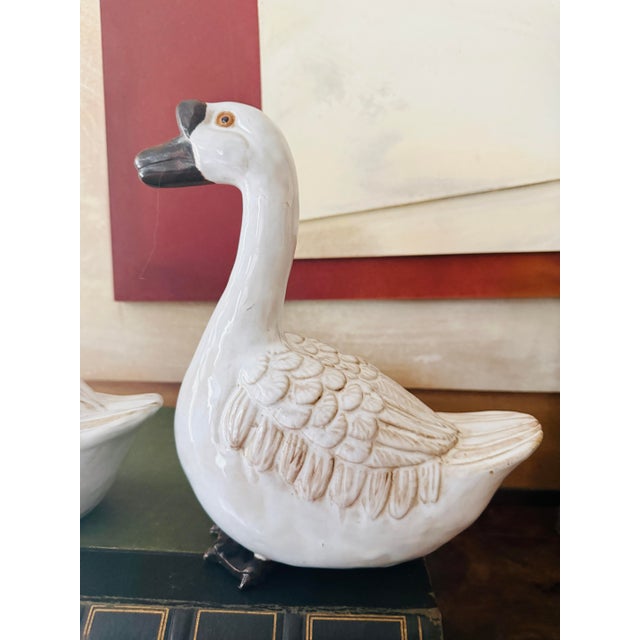 A sculptural pair of vintage Wildwood ceramic geese finished in a warm sepia-toned glaze layered over soft cream. The...