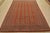 A tribal Bokhara rug, hand-knotted with fine wool on a cotton foundation. This rug features rows of repeating medallions...