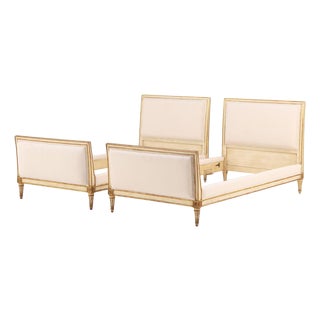 A Pair of French Louis XVI Style Painted and Gilt Twin Beds, C. 1940. For Sale