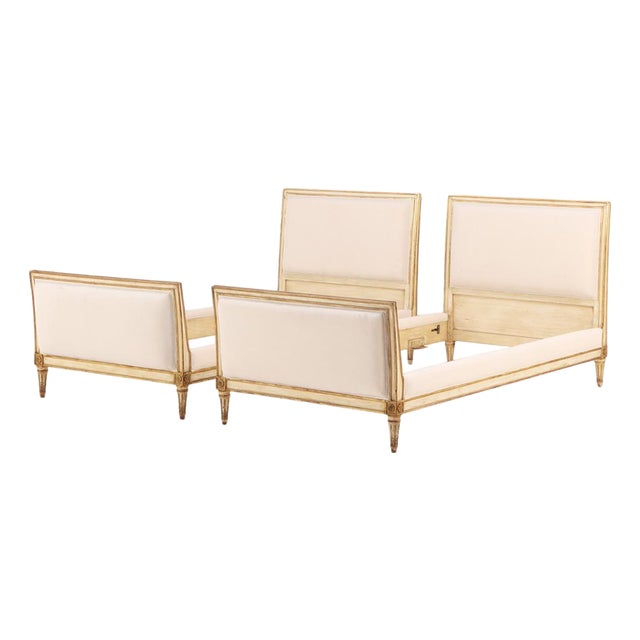 A Pair of French Louis XVI Style Painted and Gilt Twin Beds, C. 1940. For Sale