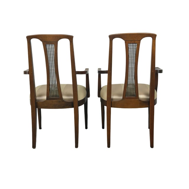 A distinctive pair of vintage mid-century modern dining armchairs featuring exceptionally tall, architectural backs,...