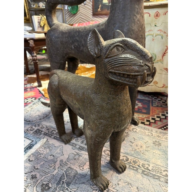 Pair of antique bronze leopard sculptures. Folk art from Benin, early 20th century. The royal leopard of Benin represents...