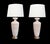 each tall lamp with everted neck above a tapering body all in a textured ivory and tan surface; raised on patinated metal...