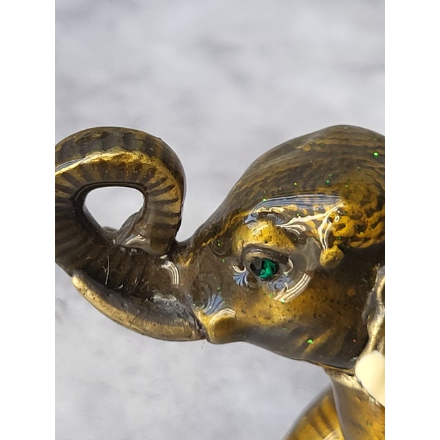 Adorable jeweled elephant trinket box with his lucky trunk upright. The hinged opening is magnetic for easy access.