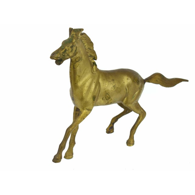 This vintage brass horse figurine captures a sense of spirited movement with its graceful, galloping silhouette. Rather...