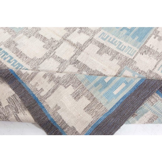 A modern flat-weave area rug, being a typical representative of the timeless Swedish school of design. It is woven...