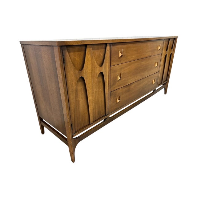 This iconic Mid-Century Modern Broyhill Brasilia walnut sideboard is one of the most sought-after designs of the era,...
