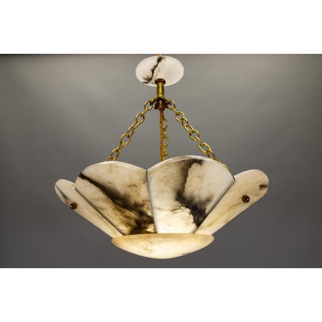 Elegant french art deco pendant light with radial segmented shade in flower form, crafted from veined alabaster and brass,...
