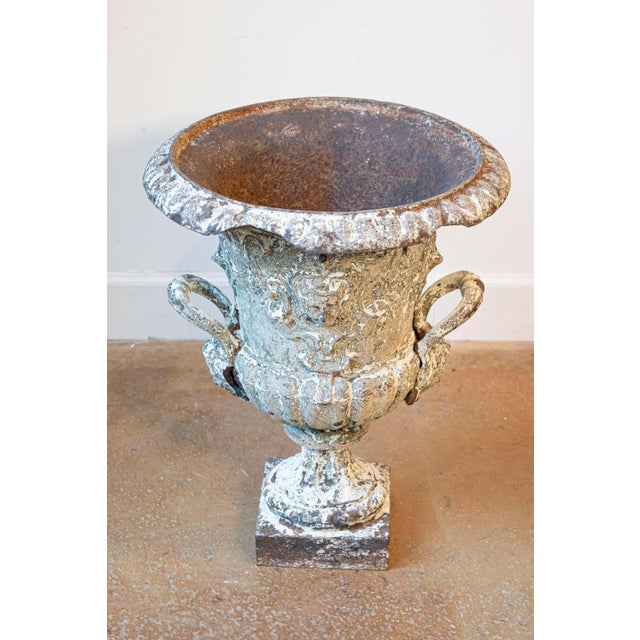 This impressive 19th-century French urn is crafted from cast iron and showcases exquisite detailing that reflects the...