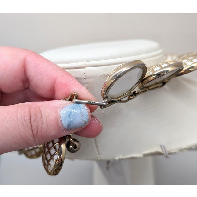 1950s goldtone circular links of "caged" round domed white resin necklace with hook clasp. Marked "NAPIER" on the hook....
