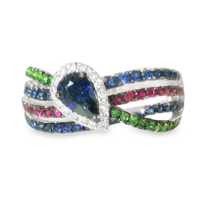Stunning 18K white gold band ring featuring a vibrant mix of natural gemstones. This exquisite piece showcases 16...