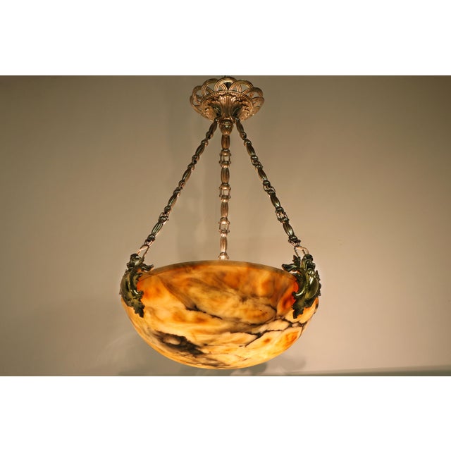 Gorgeous Neoclassical alabaster chandelier / pendant. Fully hand carved alabaster shade with gorgeous colors and grain....