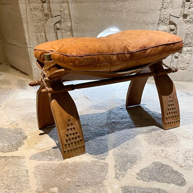 AMBIANIC presents: Vintage Egyptian Camel Stool Wood with Raw Hide Rope Ties. Leather on Stool with Embossed Drawings...