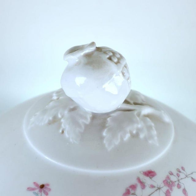 This refined ginori porcelain tureen is a magnificent piece of italian design, featuring a glossy white finish and floral...