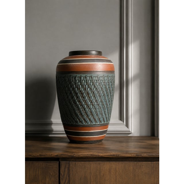 A striking and highly decorative handcrafted ceramic vase from west germany, dating from the 1960s and attributed to bay...