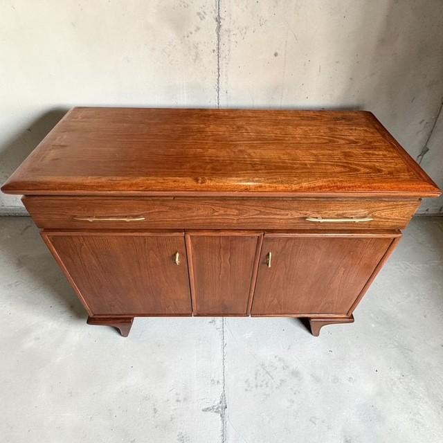 This beautifully refinished Mid-Century Modern walnut buffet/server, dating to the early 1960s, features a distinctive...