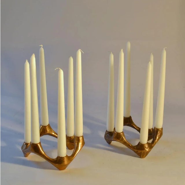 Pair of organic bronze cast candelabras form a circle of six alternating candles with original patina. They will make...